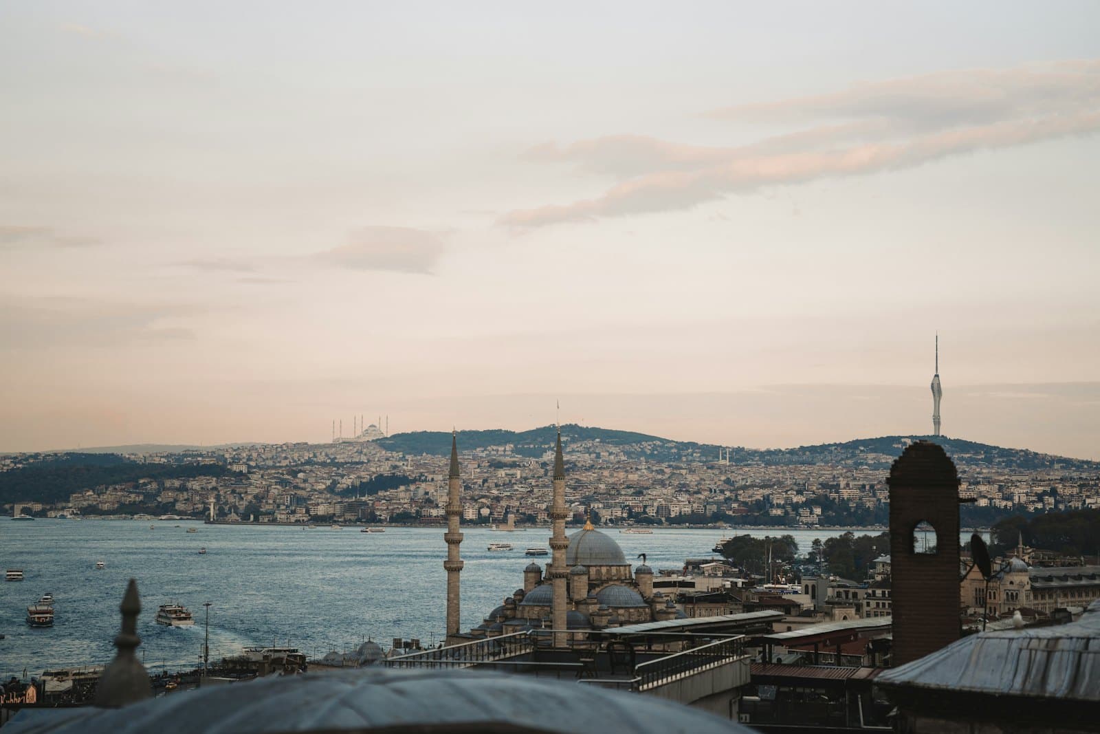 The Istanbul skyline over the Bosphorus, with mosques and minarets at dusk
